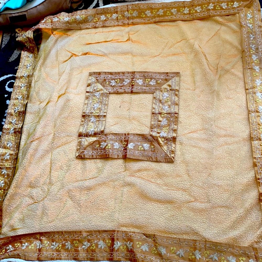 Beautiful ornate tablecloth with gold and copper
